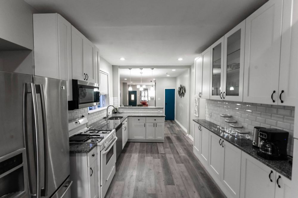 Kitchen with white cabinets, stainless appliances and granite counters